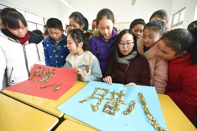 January 4, 2017 - Lianyungang, Lianyungang, China - Lianyungang, CHINA-January 4 2017: (EDITORIAL USE ONLY. CHINA OUT)..Pupils learn to recognize five kinds of cereals under the guidance of teacher at a primary school in Donghai County, Lianyungang City,east China s Jiangsu Province, January 4th, 2017, celebrating the Laba Rice Porridge Festival which falls on January 5th this year. The Laba Rice Porridge Festival is a traditional Chinese festival falls on the 8th day of the 12th month of lunar calendar. It s customary on this day to drink the special porridge, usually stewed of at least eight ingredients. With rice as the main ingredient, this porridge may well contain ingredients like broad beans, red beans, mung beans, red dates, peanuts, chest nuts, both tasty and nutritious. Lianyungang China - ZUMAs145 20170104_zaa_s145_196
