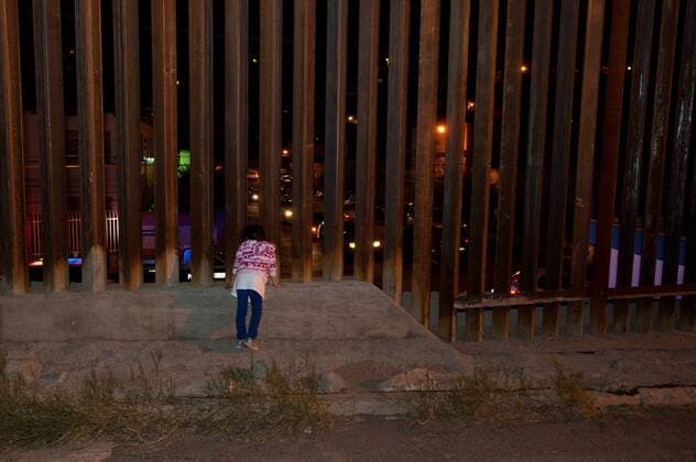 January 25, 2107 - File - President Trump signed executive orders to begin the construction of a wall on the US-Mexico border, boosting border patrol forces and increasing the number of immigration enforcement officers who carry out deportations. Pictured: Nov. 2, 2012 - Nogales, Arizona, U.S - A little girl looks through the border wall into Nogales, Sonora, Mexico after a bi-national Dia de los Muertos procession. Civil rights groups No More Deaths, Tucson s Coalicion de Derechos Humanos, Sonora-based Hogar de Esperanza y Paz (HEPAC), and Mexico s Yo Soy 132 hosted a Dia de los Muertos procession in Nogales, Arizona and Nogales, Sonora, Mexico in memory of Jose Antonio Elena Rodriguez who was shot by U.S. Border Patrol three weeks ago after allegedly throwing rocks from Nogales at agents in the U.S. and Ramses Barron who was shot by Border Patrol in Jan. 2011 Nogales U.S. - ZUMAs117 20170125_sho_s117_096 Copyright: xWillxSebergerx