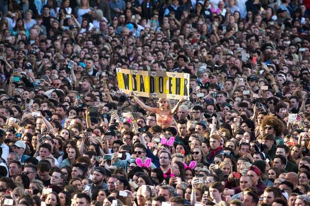 June 4, 2017 - Manchester, Greater Manchester, UK - Manchester , UK . A woman holds up a We Stand Together banner with Manchester worker bees stuck around the outside . The One Love Manchester benefit concert for victims of the Manchester Arena terrorist attack , at the Emirates Old Trafford Cricket Stadium . Ariana Grande, Justin Bieber, Coldplay, Katy Perry, Miley Cyrus, Pharrell Williams, Usher, Take That, Robbie Williams, Black Eyed Peas and Niall Horan are amongst the performers. Manchester UK - ZUMAl94_ 20170604_zaf_l94_224 Copyright: xJoelxGoodmanx