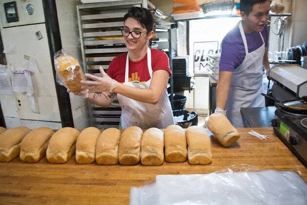 August 31, 2017 - U.S. - Marla Brose -- Laura Hosek, left, and Malachi Baldwin, right, slice and bag loaves of fresh bread at Golden Crown Panaderia in Albuquerque, N.M., Thursday, August 31, 2017. The bread, all freshly baked White Pullman bread, will be delivered to the Houston area for distribution to Hurricane Harvey victims, Thursday, August 31, 2017. U.S. - ZUMAab1_ 20170831_zaf_ab1_013 Copyright: xAlbuquerquexJournalx