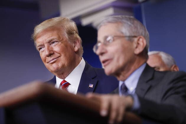 Anthony Fauci, director of the National Institute of Allergy and Infectious Diseases, speaks as U.S. President Donald Trump, left, and U.S. Vice President Mike Pence, right, listen during a Coronavirus Task Force news conference in the briefing room of the White House in Washington, DC on Friday, March 20, 2020. Americans will have to practice social distancing for at least several more weeks to mitigate U.S. cases of Covid-19, Anthony S. Fauci of the National Institutes of Health said today. WAX20200320932 ALxDRAGO