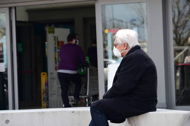 (200321) -- ROME, March 21, 2020 (Xinhua) -- A man waits to enter a supermarket in Bologna, Italy, March 20, 2020. Italy s Ministry of Health on Friday took the unprecedented step of closing all public parks, gardens and other open spaces, effective from Saturday. The coronavirus pandemic has claimed 4,032 lives in locked down Italy by Friday, with the number of cumulative cases reaching 47,021, according to new data released by the Civil Protection Department. (Photo by Gianni Schicchi Xinhua) ITALY-COVID-19-LOCKDOWN