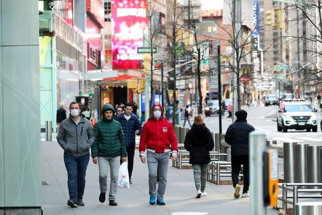 (200322) -- NEW YORK, March 22, 2020 -- Pedestrians walk along a side street near Times Square in New York, the United States, March 21, 2020. Governor of the U.S. state of New York Andrew Cuomo said on Saturday that a total of 10,356 people in the state had tested positive for novel coronavirus, jumping 3,254 compared with the previous day. On Friday, Cuomo announced that a mandate, which requires people working in non-essential businesses to stay at home, will take effect Sunday night. ) U.S.-NEW YORK-COVID-19-MANDATE WangxYing