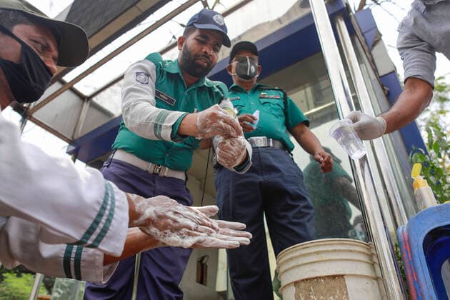 March 22, 2020, Dhaka, Dhaka, Bangladesh: Bangladeshi security officials take precaution during the spread of coronavirus, in Dhaka, Bangladesh, March 22, 2020. 3 more tested positive for COVID-19, raising the number of coronavirus patients to 27 in Bangladesh. The Bangladeshi government has imposed a restriction on all kinds of political, social, cultural and religious gatherings in an effort to contain the further spread of novel coronavirus in the country. Besides, people having fever, cough, influenza or other symptoms of COVID-19 as well as family members of coronavirus-infected patients and those come in contact with the patients have been asked not to go to mosques and other worship places. Dhaka Bangladesh - ZUMAd117 20200322_zap_d117_003 Copyright: xSuvraxKantixDasx