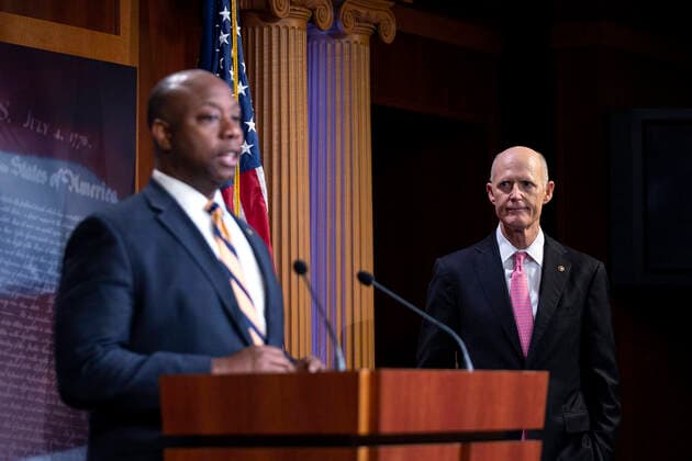 March 25, 2020, Washington, District of Columbia, USA: United States Senator Rick Scott (Republican of Florida), right, listens as United States Senator Tim Scott (Republican of South Carolina) speaks during a news conference with United States Senator Lindsey Graham (Republican of South Carolina) and United States Senator Ben Sasse (Republican of Nebraska), not pictured, at the United States Capitol in Washington D.C., U.S. on Wednesday, March 25, 2020. The Senators are calling for a correction to a supposed drafting error in the Coronavirus Stimulus Package that the Senate was set to vote on today, stating it incentivizes unemployment. Â Credit: CNP Washington USA - ZUMAs152 20200325_zaa_s152_084 Copyright: xStefanixReynoldsx