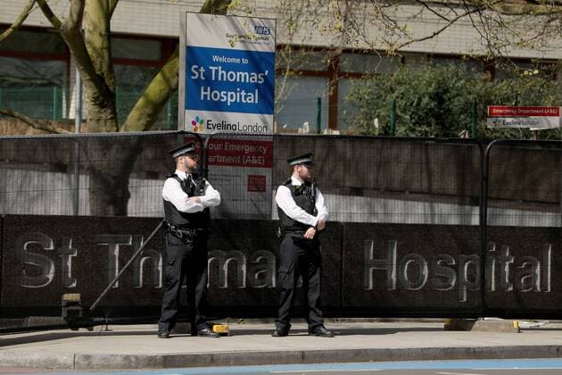 (200407) -- LONDON, April 7, 2020 (Xinhua) -- Policemen stand outside St. Thomas Hospital, where British Prime Minister Boris Johnson remains in care after being admitted with coronavirus symptoms, in London, Britain, April 7, 2020. British Prime Minister Boris Johnson was taken to intensive care on Monday night after his coronavirus symptoms worsened, Downing Street said. The prime minister, 55, was admitted to St Thomas Hospital in London with persistent symptoms on Sunday night, 10 days after testing positive for coronavirus. (Photo by Tim Ireland Xinhua) BRITAIN-LONDON-COVID-19-BORIS JOHNSON-HOSPITAL