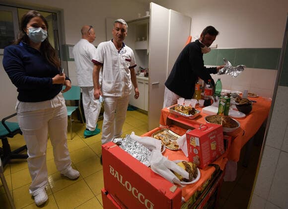 (200412) -- ROME, April 12, 2020 (Xinhua) -- Medical workers prepare to enjoy special Easter breakfast at Santo Spirito Hospital in Rome, Italy, April 12, 2020. The coronavirus pandemic has claimed 19,468 lives in locked-down Italy, bringing the total number of infections, fatalities and recoveries so far to 152,271, according to the latest data released by the country s Civil Protection Department on Saturday. (Photo by Alberto Lingria Xinhua) ITALY-ROME-COVID-19-MEDICAL WORKER