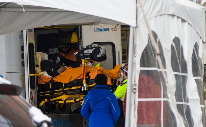 (201228) -- TORONTO, Dec. 28, 2020 -- A patient is wheeled out from an ambulance to the hospital in Toronto, Ontario, Canada, Dec. 27, 2020. Canada s COVID-19 cases surpassed 550,000, with the total hitting 552,020, including 14,963 deaths, as of Sunday afternoon, according to CTV. Ontario, the most populous province in Canada, reported 2,005 new cases, bringing its total case count to 171,416 on Sunday. (Photo by Xinhua) CANADA-ONTARIO-COVID-19 ZouxZheng