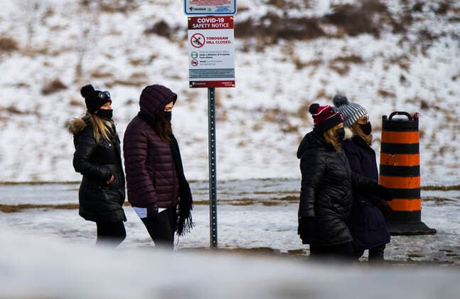 (210116) -- ONTARIO, Jan. 16, 2021 -- People wearing face masks walk past a closed toboggan hill in Vaughan, Ontario, Canada, on Jan. 16, 2021. Canada s COVID-19 cases surpassed 700,000 on Saturday morning, with the total hitting 700,988, including 17,847 deaths, according to CTV. (Photo by Xinhua) CANADA-ONTARIO-COVID-19-CASES ZouxZheng