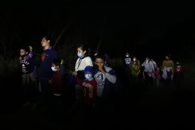 February 24, 2021, Mission, Texas, USA: Migrant families are guided to a U.S. Border Patrol processing area by Hidalgo County Precinct 3 Constable deputies in an area known as Devilâ€⠢s Corner in Mission, Texas, Wednesday, Feb. 24, 2021. As the sun set, smugglers known as coyotes, started crossing mostly Central American families across the Rio Grande from Mexico into the U.S.. The migrants surrendered to U.S. Border Patrol agents. Mission USA - ZUMAa27_ 20210224_znn_a27_016 Copyright: xSanxAntonioxExpress-Newsx