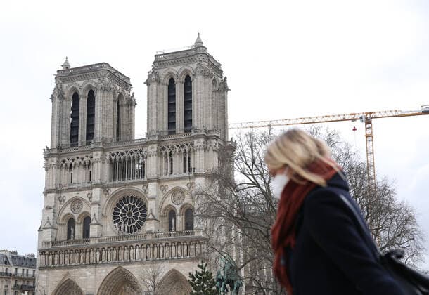 (210317) -- PARIS, March 17, 2021 -- A woman wearing a mask walks near the Notre Dame de Paris cathedral in Paris, France, March 17, 2021. France has entered a form of third wave (of the coronavirus pandemic) characterized by numerous virus variants, Prime Minister Jean Castex said on Tuesday, stressing that his government still considers vaccination a top priority of its strategy to stem the spread of the virus. On Tuesday, the health authorities reported 29,975 new infections across the country, bringing the cumulative total to 4,108,108. The number of single-day deaths jumped to 408, taking the total to 91,170. ) FRANCE-PARIS-COVID-19-THIRD WAVE GaoxJing