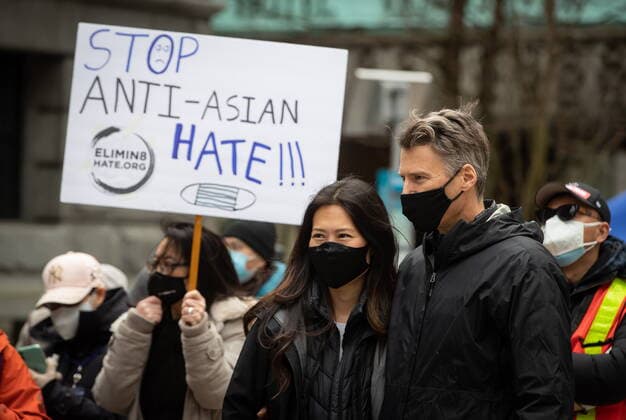 March 28, 2021, Vancouver, BC, Canada: Korean-American journalist Eileen Park, left, and her husband, former Vancouver mayor Gregor Robertson attend a rally opposing discrimination against Asian communities and to mourn the victims of those affected by the Atlanta shootings, in Vancouver, B.C., on Sunday, March 28, 2021. Vancouver Canada - ZUMAc35_ 20210328_zaf_c35_117 Copyright: xDarrylxDyckx