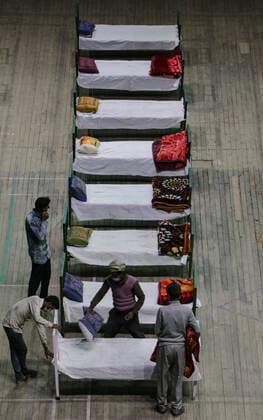 COVID-19: Jammu and Kashmir records 3,164 new cases, 25 deaths SRINAGAR, INDIA, 27 APRIL 2021 - Workers prepare beds at a new makeshift Covid-19 quarantine facility with the capacity of 111 beds inside the Indoor Sports Stadium in Srianagar. After Jammu and Kashmir recorded its highest single-day spike of 3,164 COVID-19 cases, which took the tally to 166,054, while 25 fatalities over the last 24 hours took the toll to 2,197, officials said. SRINAGAR Jammu And Kashmir India Copyright: AdilxAbass