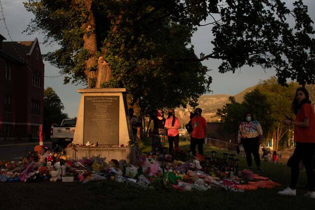 June 4, 2021, Kamloops, BC, Canada: People gather around a makeshift memorial at a monument outside the former Kamloops Indian Residential School, honouring the 215 children whose remains have been discovered buried near the facility, in Kamloops, B.C., on Friday, June 4, 2021. Kamloops Canada - ZUMAc35_ 20210604_zaf_c35_165 Copyright: xDarrylxDyckx