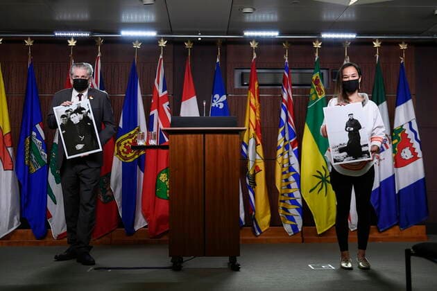 July 8, 2021, Ottawa, on, Canada: NDP MP Mumilaaq Qaqqaq, right, holds a photo of Fr. Johannes Rivoire, who is wanted in Canada for abusing children in Nunavut but now resides in France, as NDP MP Charlie Angus holds a photo of Fr. Arthur Lavoie, who died in 1991 and was named in over 300 reports of physical and sexual abuse, as they arrive for a news conference calling on Minister of Justice David Lametti to investigate crimes against Indigenous people in Canada at residential schools, on Parliament Hill in Ottawa, on Thursday, July 8, 2021. Ottawa Canada - ZUMAc35_ 20210708_zaf_c35_009 Copyright: xJustinxTangx