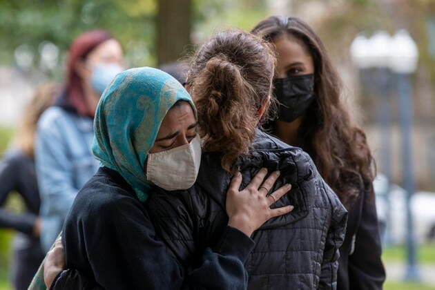 September 27, 2021, Kingston, on, Canada: Meena Waseem from the Sexual Assault Centre of Kingston, hugs a sexual assault victim after she spoke to Queen s University student who organize a walkout to protest sexual assault on campuses and in and in support of the victims of sexual assault at Western University, in Kingston, Ont.,, on Monday Sep. 27, 2021. Kingston Canada - ZUMAc35_ 20210927_zaf_c35_028 Copyright: xLarsxHagbergx