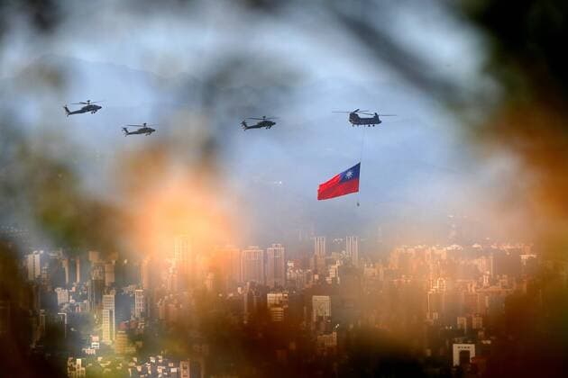 October 5, 2021, New Taipei, Taipei, Taiwan: A military helicopter carrying a tremendous Taiwan flag conducts a flyby rehearsal with other helicopters ahead of the Double-tenth national day celebration, near Taipei 101, amid China s growing military threats. China has been sending record number of warplanes to the ADIZ of the self ruled island, whilst Taiwan has been building better relations with the US, Australia, Japan, and other European countries. New Taipei Taiwan - ZUMAs313 20211005_zip_s313_003 Copyright: xDanielxCengxShou-Yix