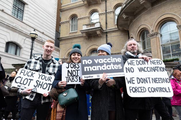 January 22, 2022, London, England, United Kingdom: (EDITOR™S NOTE: Image contains profanity).Protestors seen holding placards that say fuck your clot shot , jobs not jabs , no vaccine mandates , and we don t need no vaccination. we don t need no forced control! during the demonstration..By April 2022, 100k members of the NHS will have to be fully vaccinated or lose their jobs. In light of this draconian requirement, NHS nurses have come together to protest against such coercion, defending their medical freedom and accusing the government for a total mistreatment of the health workers over the pandemic. Other anti-lockdown and anti-vaccine groups have jointly protested against the restrictions imposed by the government, and threaten t - ZUMAs197 20220122_zaa_s197_153 Copyright: xBelindaxJlaox