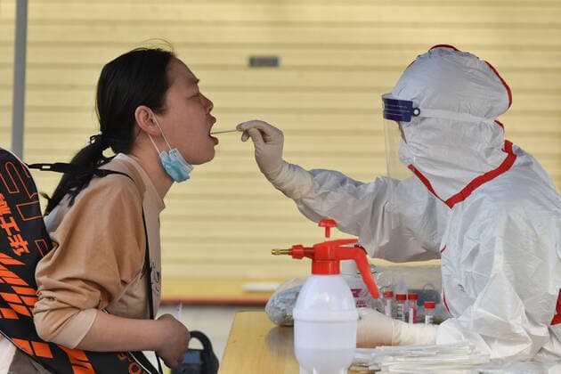 April 10, 2022, Fuyang, Anhui, China: A health worker wearing a Personal Protective Equipment (PPE) collects swab samples from a resident in Fuyang. The Chinese mainland reported 1,318 new locally-transmitted confirmed covid-19 cases on Saturday, down from 1,334 on Friday, the National Health Commission said. Of the local confirmed cases reported Saturday, 1,006 were in Shanghai, 242 in Jilin, 16 in Zhejiang, 10 in Guangdong, and three in Beijing. The rest were reported in 12 other provincial-level regions. Fuyang China - ZUMAs197 20220410_zaa_s197_023 Copyright: xSheldonxCooperx