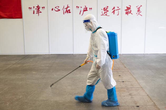 (220414) -- SHANGHAI, April 14, 2022 -- A staff member disinfects an area in the convention center-turned makeshift hospital at the Shanghai New International Expo Center (SNIEC), in Shanghai, east China, April 14, 2022. The convention center-turned makeshift hospital has a capacity to accommodate more than 14,000 beds, and medical workers serving in the hospital are from various provinces and cities such as Hubei, Tianjin and Jiangxi. Over 9,000 COVID-19 patients have been discharged from the SNIEC as of Thursday. ) CHINA-SHANGHAI-SNIEC-MAKESHIFT HOSPITAL (CN) JinxLiwang
