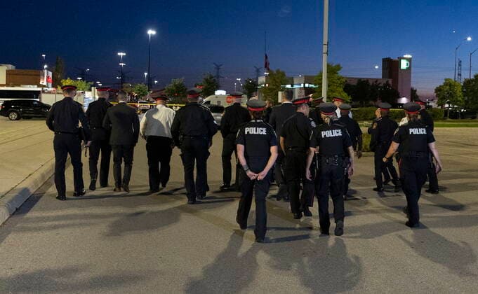 September 12, 2022, Mississauga, ON, CANADA: Police officers walk away after speaking to the media at the scene of a shooting in Mississauga, Ont., Monday, Sept. 12, 2022. Cst. Andrew Hong, of the Toronto Police Service, was fatally shot after two separate shootings left two dead and three injured in the Greater Toronto Area on Monday afternoon. Mississauga CANADA - ZUMAc35_ 20220912_zaf_c35_190 Copyright: xArlynxMcadoreyx