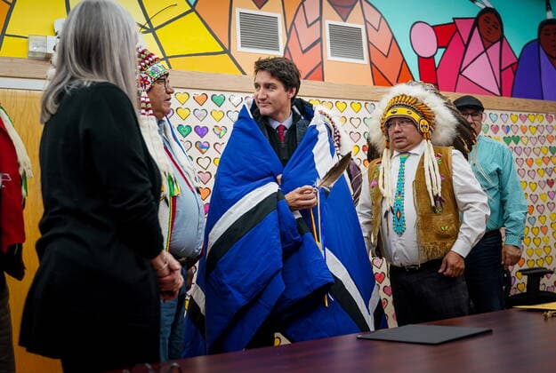 November 28, 2022, James Smith Cree Nation, SK, Canada: Prime Minister Justin Trudeau, middle receives a blanket from Chakastaypasin Chief Calvin Sanderson, left, and James Smith Cree Nation Chief Wally Burns, right, at James Smith Cree Nation, Sask., on Monday, November 28, 2022. James Smith Cree Nation Canada - ZUMAc35_ 20221128_zaf_c35_099 Copyright: xHeywoodxYux