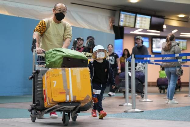 January 4, 2023, RICHMOND, BC, CANADA: A man and young boy who arrived on a Cathay Pacific flight from Hong Kong walk together at Vancouver International Airport, in Richmond, B.C., on Wednesday, January 4, 2023. Starting Thursday, Canada will require air travellers from China, Hong Kong and Macau to have a recent negative COVID-19 test result. RICHMOND CANADA - ZUMAc35_ 20230104_zaf_c35_067 Copyright: xDarrylxDyckx