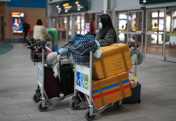 January 4, 2023, RICHMOND, BC, CANADA: A passenger who arrived on a Cathay Pacific flight from Hong Kong stands with baggage on carts while waiting for other family members at Vancouver International Airport, in Richmond, B.C., on Wednesday, January 4, 2023. Starting Thursday, Canada will require air travellers from China, Hong Kong and Macau to have a recent negative COVID-19 test result. RICHMOND CANADA - ZUMAc35_ 20230104_zaf_c35_071 Copyright: xDarrylxDyckx