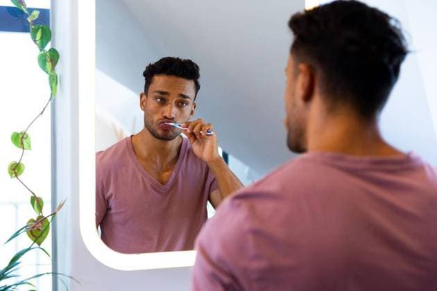 Biracial man looking at himself in mirror and brushing teeth in bathroom Biracial man looking at himself in mirror and brushing teeth in bathroom. Lifestyle, self care and domestic life, unaltered., model released, , property released, Cape Town, South Africa, 2023-03-01T22:00:00.000Z, 3990407.jpg, people,biracial,man,looking,mirror,brushing teeth,bathroom,lifestyle,self care,domestic life,unaltered,young,adult,person,bath,portrait,happy,attractive,leisure,hygiene,casual,smile,toilet,healthy,smiling,cheerful,pretty,face,happiness,beautiful,brushing,teeth,self,care,domestic,life Young Adult,Man,Male,Hispanic or Latino