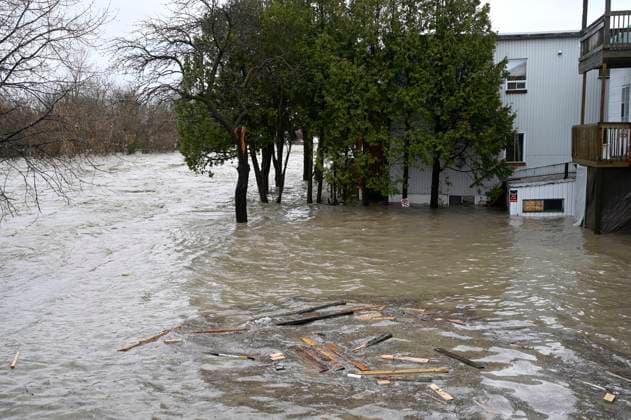 May 1, 2023, BAIE SAINT-PAUL, PQ, CANADA: Flood waters surround a home by the River Brtas-du-Nord, Monday, May 1, 2023 in Baie Saint-Paul, Quebec. Provincial police searched on Monday for two people swept away by the current on the flooded Rivio¨re du Gouffre, in Quebec s Charlevoix region, where up to 60 millimetres of rain fell within a 24-hour period. BAIE SAINT-PAUL CANADA - ZUMAc35_ 20230501_zaf_c35_092 Copyright: xJacquesxBoissinotx