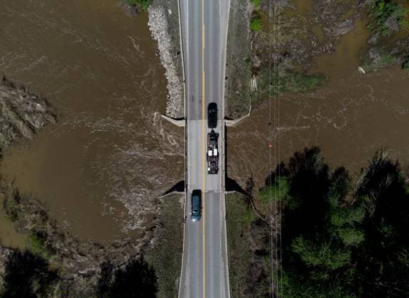 May 14, 2023, CACHE CREEK, BC, CANADA: Motorists traveling on the Cariboo Highway cross a bridge over the swollen Bonaparte River, north of Cache Creek, B.C., on Sunday, May 14, 2023. Environment Canada says unseasonably hot temperatures in British Columbia will persist over the coming days, with special weather statements warning of high river streamflows due to melting snow in hard-hit communities in the province s interior. CACHE CREEK CANADA - ZUMAc35_ 20230514_zaf_c35_114 Copyright: xDarrylxDyckx