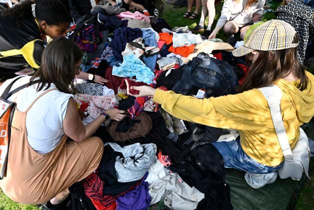 May 27, 2023, Ottawa, ON, CAN: Bargain hunters dig through a selection of clothes laid out in a pile on a tarp at the Great Glebe Garage Sale, in Ottawa, on Saturday, May 27, 2023. The community event draws thousands of people to the Glebe, one of OttawaöÄÃ s heritage neighbourhoods, with vendors donating a percentage proceeds to the Ottawa Food Bank. Ottawa CAN - ZUMAc35_ 20230527_zaf_c35_016 Copyright: xJustinxTangx