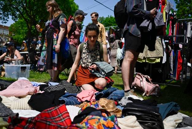 May 27, 2023, Ottawa, ON, CAN: A bargain hunters looks at clothes laid out on a lawn at the Great Glebe Garage Sale, in Ottawa, on Saturday, May 27, 2023. The community event draws thousands of people to the Glebe, one of OttawaöÄÃ s heritage neighbourhoods, with vendors donating a percentage proceeds to the Ottawa Food Bank. Ottawa CAN - ZUMAc35_ 20230527_zaf_c35_025 Copyright: xJustinxTangx