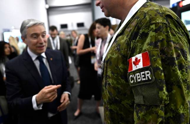 June 1, 2023, Ottawa, ON, CAN: Industry Minister Franvßois-Philippe Champagne speaks with a Canadian Forces member working in the Cyber Forces, at the CANSEC trade show, billed as North AmericaöÄÃ s largest multi-service defence event, in Ottawa, on Thursday, June 1, 2023. Ottawa CAN - ZUMAc35_ 20230601_zaf_c35_030 Copyright: xJustinxTangx