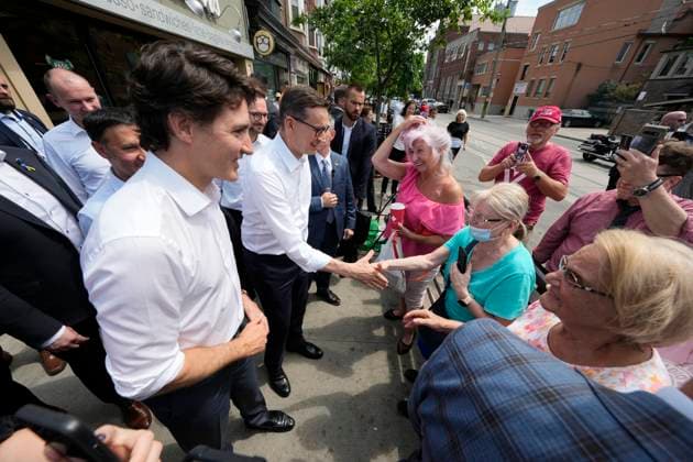 June 2, 2023, TORONTO, ON, Canada: Poland Prime Minister Mateusz Morawiecki, centre, shakes hands with members of the public on the sidewalk as Prime Minister Justin Trudeau, left, looks on during a visit to a bakery and deli in Toronto on Friday, June 2, 2023. TORONTO Canada - ZUMAc35_ 20230602_zaf_c35_061 Copyright: xFrankxGunnx