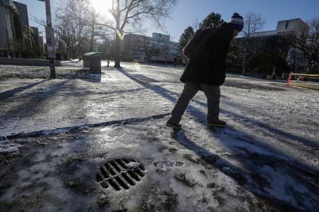 (240113) -- VANCOUVER, Jan. 13, 2024 -- A pedestrian walks on the frozen pavement at the University of British Columbia in Vancouver, British Columbia, Canada, on Jan. 12, 2024. Environment Canada issued weather warnings, statements and watches in every province and territory across the country on Friday morning. Extreme cold is an issue on the West Coast, in the Prairies and in northern Canada, where it may feel as cold as minus 55 Celsius, CTV News reported. (Photo by Xinhua) CANADA-VANCOUVER-EXTREME COLD WEATHER LiangxSen