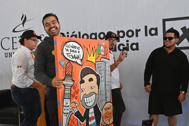 May 22, 2024, Tijuana, Baja California, Mexico: Mexican presidential candidate Jorge Alvarez Maynez of the Citizens Movement party (MC), receives a gift from a supporter, a painting of himself that reads â€oethe new thing has already arrived in Tijuana†during a campaign stop in Tijuana, Baja California, Mexico, where he sought the youth vote at the CETYS University campus on Wednesday, May 22, 2024. Tijuana Mexico - ZUMAm180 20240522_zip_m180_025 Copyright: xCarlosxA.xMorenox