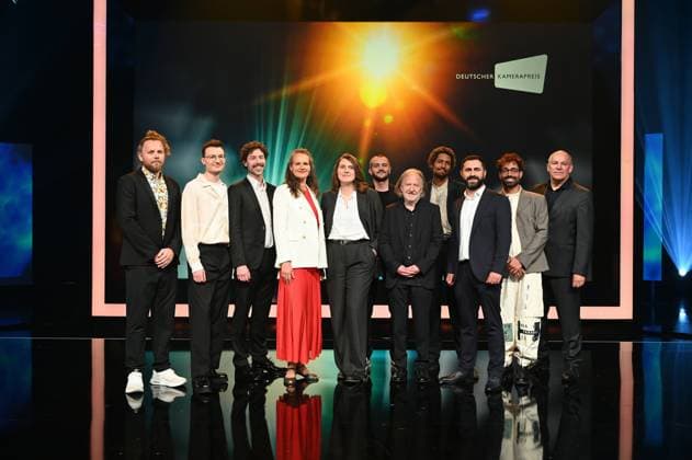 Award winners Lukas Wunschik, Markus Ott, Nicolai Mehring, Anne Jünemann, Yana Höhnerbach, Philipp Straetker, Rainer Klausmann, Noah Böhm, Daniel Guliyev, Christopher Aoun, and Walter Demonte Managing Director of the association DEUTSCHER KAMERAPREIS e V l r, pose on stage at the award ceremony 34 German Camera Award