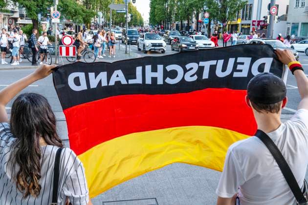 Young soccer fans celebrate Germanys victory in the match against Hungary, waving German flags on Leopoldstrasse, European Football Championship, Munich, June 19, 2024 Germany, Munich, June 19, 2024, soccer fans celebrate Germanys victory in the match against Hungary, waving German flags on Leop