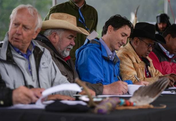 June 26, 2024, Nemaiah Valley, Bc, CANADA: Prime Minister Justin Trudeau, third left, sits between Chief Joe Alphonse, second left, and Chief Roger William, right, as they and B.C. Minister of Indigenous Relations and Reconciliation Murray Rankin, left, sign an extension of a tripartite agreement for another five years, during community celebrations to mark the 10th anniversary of the Tsilhqot in decision, in Nemaiah Valley, B.C., on Wednesday, June 26, 2024. In 2014, the Supreme Court of Canada granted Tsilhqot in aboriginal title to more than 1,750 square kilometres of land in the Nemaiah Valley. Nemaiah Valley CANADA - ZUMAc35_ 20240626_zaf_c35_150 Copyright: xDarrylxDyckx