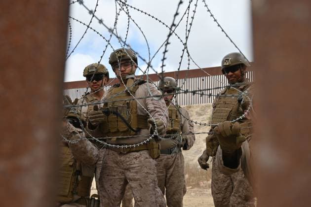 February 6, 2025, Tijuana, Baja California, Mexico: Members of the US Marine Corps install concertina wire along the US-Mexico border wall in San Diego, California, seen from Tijuana, Mexico in between the San Diego-Tijuana border fences of Colonia Libertad on Thursday, February 06, 2025. The Defense Department deployed 1,600 active-duty troops to the border during US President Donald Trumpâ€⠢s first week in office. Tijuana Mexico - ZUMAm180 20250206_zip_m180_009 Copyright: xCarlosxA.xMorenox