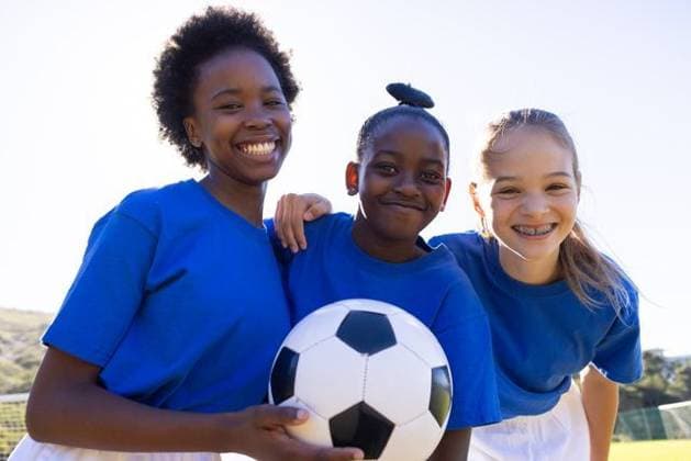 Smiling school diverse girls holding soccer ball, enjoying outdoor sports activity together Smiling school diverse girls holding soccer ball, enjoying outdoor sports activity together. Children, teamwork, recreation, fun, playing, exercise, model released, , property released, Cape Town, South Africa, 18.05.2024, 5565308.jpg, people,smiling,school,girls,soccer,ball,outdoor,sports,activity,teamwork,recreation,fun,playing,exercise,children,friendship,diversity,athletic,happiness,unaltered,joy,leisure,girls sports,youth,outdoor play,group,fitness,competition,engagement,camaraderie,active,energetic,playtime,schoolyard,girls soccer,sportsmanship,bonding,togetherness,outdoor activities,physical activity,girls team,youth sports,soccer practice,sp