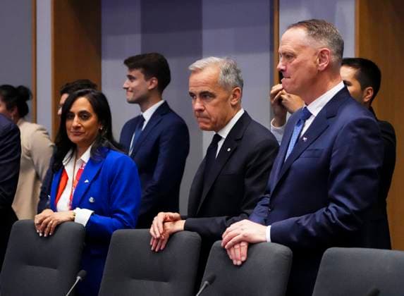 June 23, 2025, Brussels, Belgium: Prime Minister Mark Carney, centre, is flanked by Canadian Minister of Foreign Affairs Anita Anand, left, and Minister of National Defence David McGuinty, right, as they wait for the start of a plenary at the Canada EU Summit in Brussels, Belgium on Monday, June 23, 2025. Brussels Belgium - ZUMAc35_ 20250623_zaf_c35_055 Copyright: xSeanxKilpatrickx