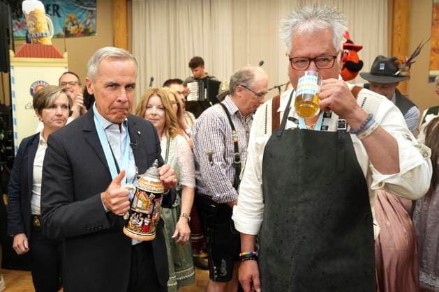 October 17, 2025, Breslau, On, Canada: Prime Minister Mark Carney, left, reacts after taking a sip of beer with Darryl Fletcher, President of the Board of Oktoberfest, at an Oktoberfest event, at the Schwaben Club in Breslau, Ont., on Friday, Oct. 17, 2025. Breslau Canada - ZUMAc35_ 20251017_zaf_c35_042 Copyright: xChrisxYoungx