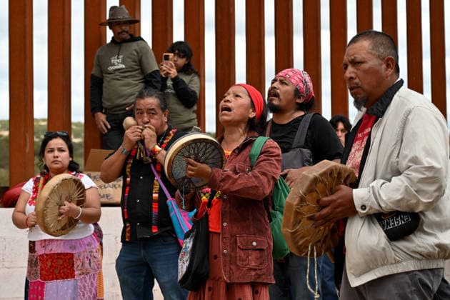 April 12, 2026, Tecate, Baja California, Mexico: Members of native communities, mainly Kumeyaay native group, perform a â€oeceremony†rally against the destruction of the Kuchamaa Mountain left by the construction of a new border wall at the US-Mexico Border in Tecate, Baja California, Mexico on Sunday, April 12, 2026. The Kuchamaa Mountain is considered a sacred site by native groups living in both sides of the border. Tecate Mexico - ZUMAm180 20260412_zip_m180_018 Copyright: xCarlosxA.xMorenox