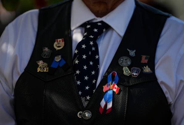 September 11, 2026, Surrey, Bc, CANADA: A man wears a ribbon with U.S. and Canadian flags during the Northwest 9 11 Memorial ceremony at the Peach Arch monument on the Canada-U.S. border between Surrey, B.C., and Blaine, Wash., in Surrey, B.C., on Friday, Sept. 11, 2026. Surrey CANADA - ZUMAc35_ 20260911_zaf_c35_134 Copyright: xDarrylxDyckx