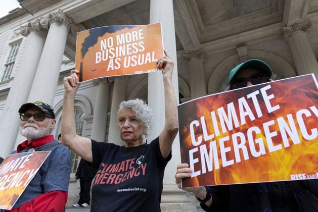 September 30, 2026, New York, New York, USA: Environmental advocates rally on the City Hall steps calling for Mayor Mamdani to keep his campaign promises to decarbonize New York City. Participants hold signs that read NO MORE BUSINESS AS USUAL CLIMATE EMERGENCY. Organizers call for the mayor to close the loophole in NYCâ€⠢s primary climate law, Local Law 97, to invest in green healthy public schools, fight fossil fuel infrastructure and fracked gas power plants. Participating organizations are Food & Water Watch, ALIGN, TREEage, NYPIRG, Rise & Resist, New York Communities for Change, Sunrise Movement NYC, Climate Defenders, Climate Defiance and Hot Girls Organize. New York USA - ZUMAr174 20260930_znp_r174_006 Copyright: xGinaxMxRandazzox