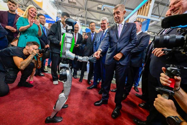 Czech Prime Minister Andrej Babis shaking hands with a humanoid robot, right, and Minister of Industry and Trade Karel Havlicek as they attend the opening of the 67th International Engineering Fair, which begins at Vystaviste 1 exhibition grounds in Brno, Czech Republic, on October 6th, 2026. International Fair of Machine Tools and Forming Machines IMT, International Welding Engineering Fair Welding, International Fair of Plastics, Rubber and Composites Plastex, International Fair of Surface Treatment Technologies Profintech and International Foundry Fair Fond-Ex also start. (CTKxPhoto VaclavxSalek) CTKPhotoP2026100605223 CTKPhotoP2026100605223