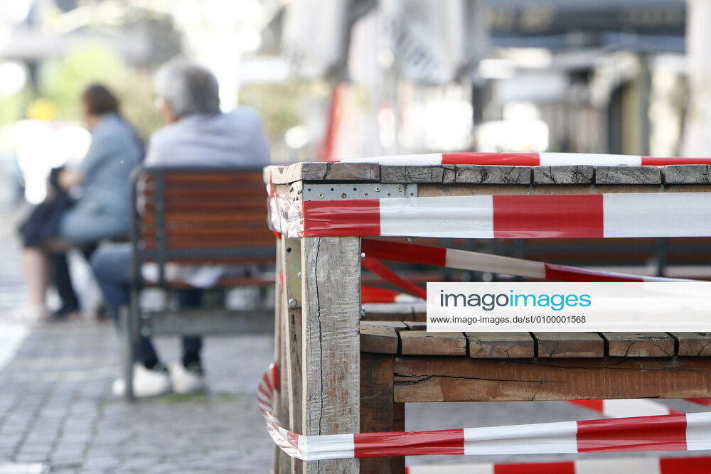 Barrier tape around tables and chairs of a closed restaurant in the city centre of Frankfurt, Hessen, Frankfurt