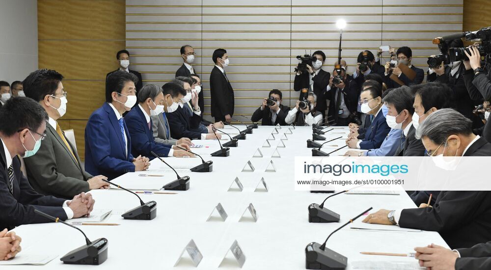 New coronavirus Japanese Prime Minister Shinzo Abe (3rd from L) attends a meeting of the government task force on combatting the new coronavirus pandemic in Tokyo on April 27, 2020.